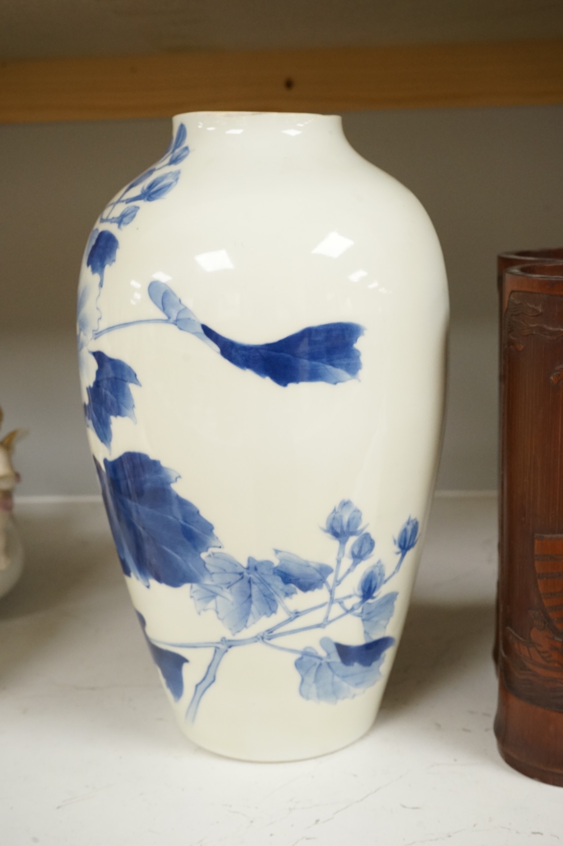 A Chinese Revolution Period porcelain bird group, 21.5cm, a pair of Chinese bamboo brushpots carved with figures and junks, each 22cm high, and a Japanese Seto blue and white vase, 29cm high